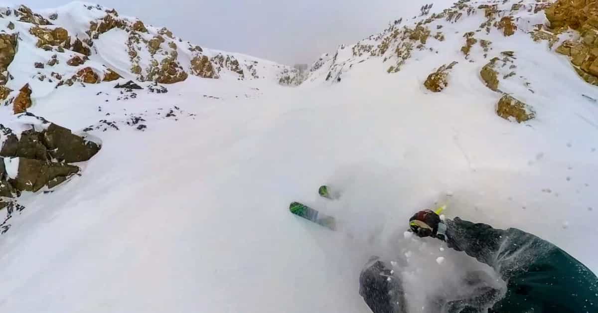 skier getting face shot in deep snow at Alta Ski Area Utah